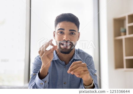 Screen view portrait young male speaking on web conference Screen view portrait young male speaking on web conference 125336644