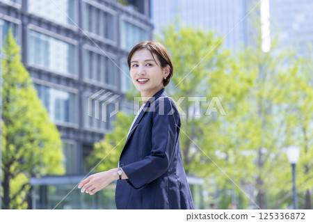 Business: Portrait of a woman walking through an office district Business: Portrait of a woman walking through an office district 125336872