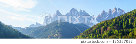 Majestic mountain range with snow-capped peaks at dawn near Valley of Funes at Dolomites, Italy Majestic mountain range with snow-capped peaks at dawn near Valley of Funes at Dolomites, Italy 125337052