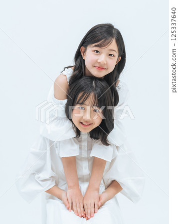 Portrait of close sisters Portrait of close sisters 125337640