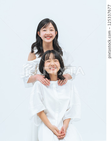 Portrait of close sisters 125337677
