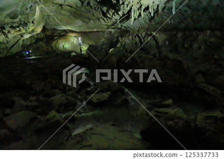 Akiyoshi Cave with umbrellas hanging from the ceiling Akiyoshi Cave with umbrellas hanging from the ceiling 125337733