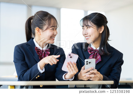 High school girls looking at their smartphones in the classroom. Photo courtesy of Denpa Gakuen, Tokyo Electronics College. High school girls looking at their smartphones in the classroom. Photo courtesy of Denpa Gakuen, Tokyo Electronics College. 125338198