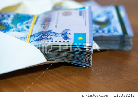 Thick wad of money cash on table 125338212