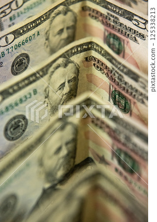 Thick wad of money cash on table Thick wad of money cash on table 125338213