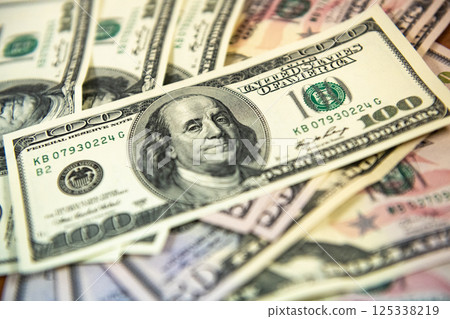 Thick wad of money cash on table Thick wad of money cash on table 125338219