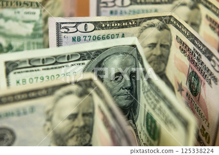 Thick wad of money cash on table Thick wad of money cash on table 125338224