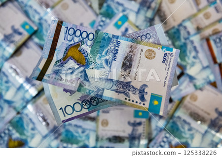 Thick wad of money cash on table Thick wad of money cash on table 125338226