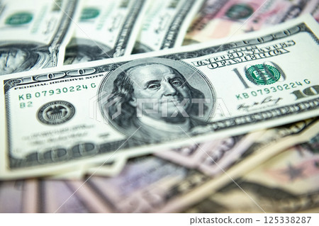 Thick wad of money cash on table Thick wad of money cash on table 125338287