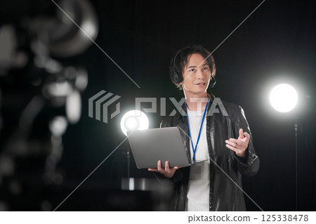 Man giving instructions on stage Man giving instructions on stage 125338478