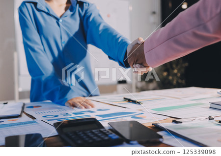 Business success. Business people shaking hands agreement confirmed in the investment business. Business success. Business people shaking hands agreement confirmed in the investment business. 125339098