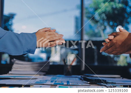 Team of businesspeople clapping hands while having a conference. Business professionals applauding at a seminar. Team of businesspeople clapping hands while having a conference. Business professionals applauding at a seminar. 125339100