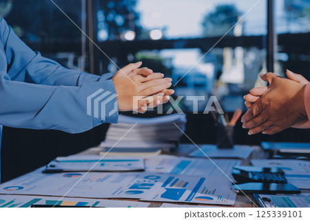 Team of businesspeople clapping hands while having a conference. Business professionals applauding at a seminar. 125339101