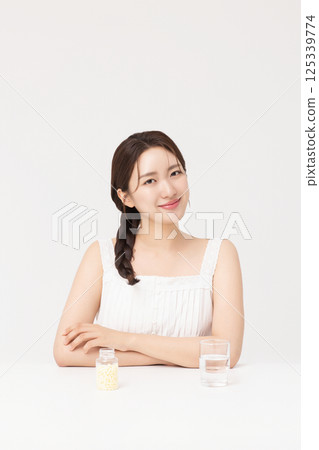 A young woman taking nutritional supplements for her health 125339774