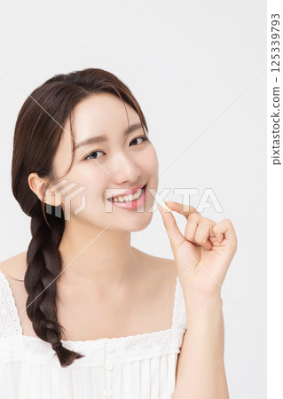 A young woman taking nutritional supplements for her health A young woman taking nutritional supplements for her health 125339793