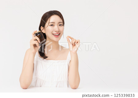 A young woman taking nutritional supplements for her health 125339833