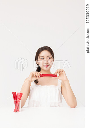 Portrait of young woman posing with health supplement products 125339919
