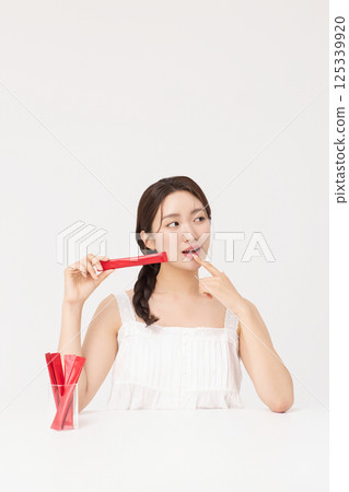 Portrait of young woman posing with health supplement products 125339920