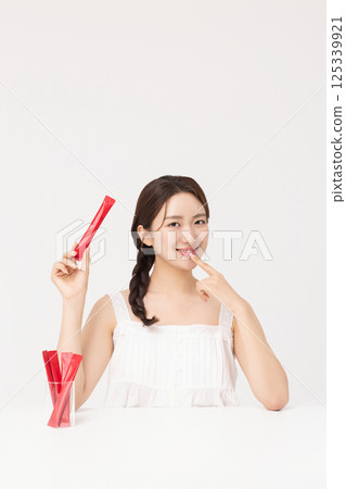 Portrait of young woman posing with health supplement products 125339921