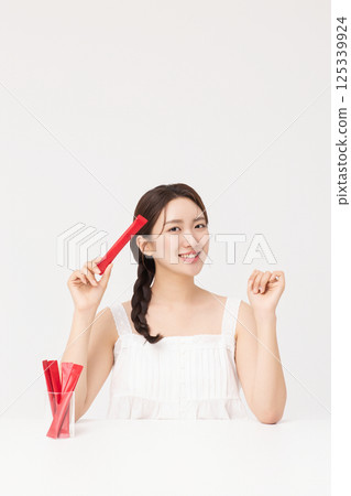 Portrait of young woman posing with health supplement products 125339924