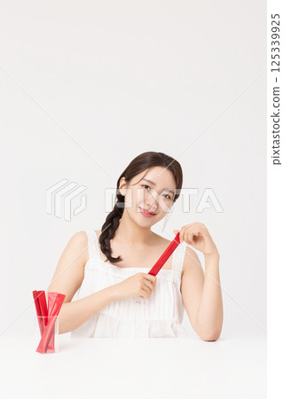 Portrait of young woman posing with health supplement products 125339925
