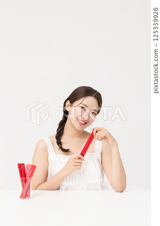 Portrait of young woman posing with health supplement products 125339926