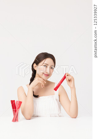 Portrait of young woman posing with health supplement products 125339927