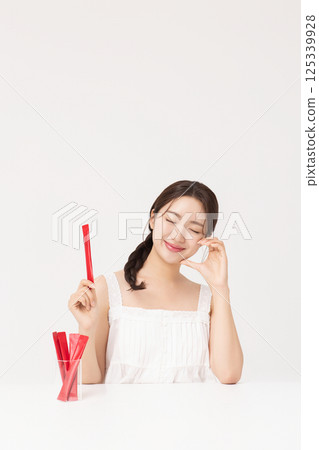 Portrait of young woman posing with health supplement products 125339928