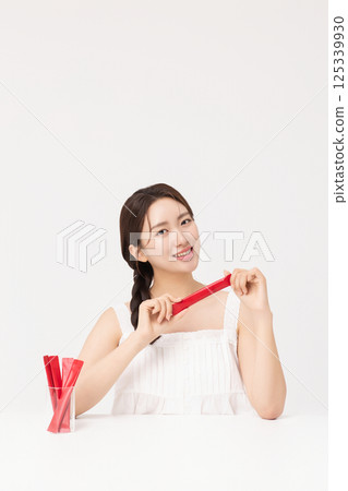 Portrait of young woman posing with health supplement products 125339930