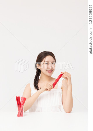 Portrait of young woman posing with health supplement products 125339935