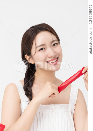 Portrait of young woman posing with health supplement products 125339942
