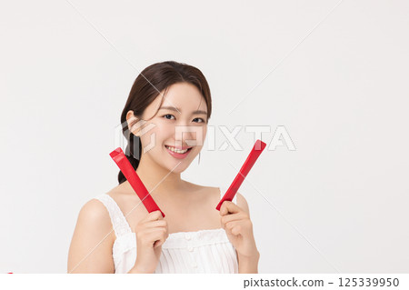 Portrait of young woman posing with health supplement products Portrait of young woman posing with health supplement products 125339950