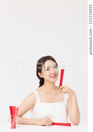 Portrait of young woman posing with health supplement products 125339955