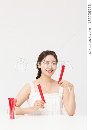 Portrait of young woman posing with health supplement products 125339956