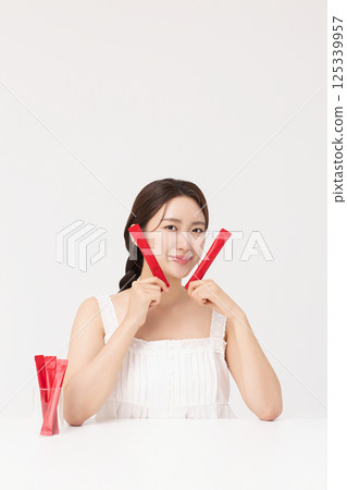 Portrait of young woman posing with health supplement products 125339957