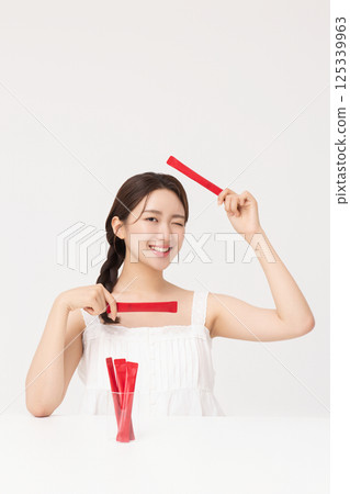 Portrait of young woman posing with health supplement products 125339963