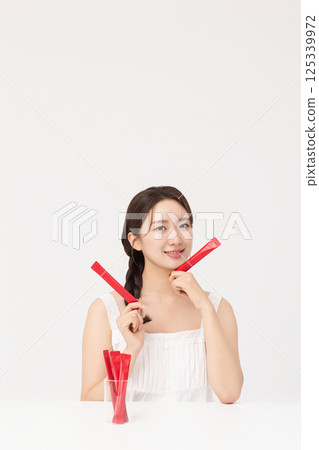 Portrait of young woman posing with health supplement products 125339972