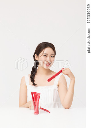 Portrait of young woman posing with health supplement products 125339989