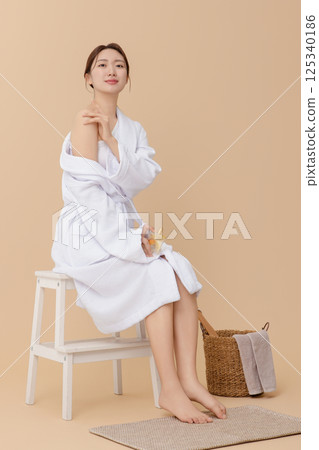 Portrait of young woman taking care of her nails 125340186