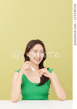 Portrait of young woman taking care of her nails 125340192