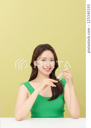 Portrait of young woman taking care of her nails Portrait of young woman taking care of her nails 125340193
