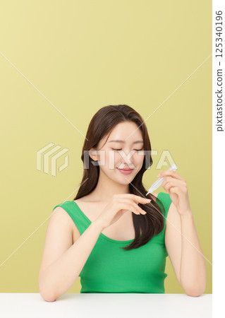 Portrait of young woman taking care of her nails 125340196