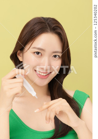 Portrait of young woman taking care of her nails Portrait of young woman taking care of her nails 125340202