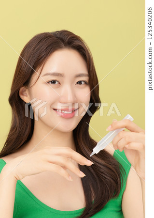 Portrait of young woman taking care of her nails 125340206