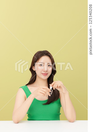 Portrait of young woman taking care of her nails 125340208