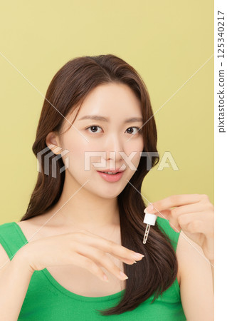 Portrait of young woman taking care of her nails 125340217