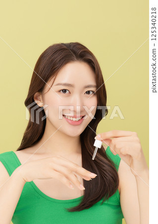 Portrait of young woman taking care of her nails 125340218