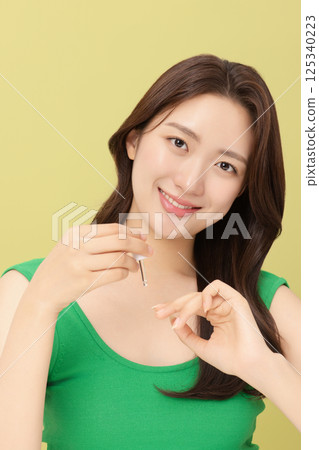 Portrait of young woman taking care of her nails 125340223