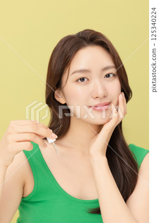 Portrait of young woman taking care of her nails 125340224