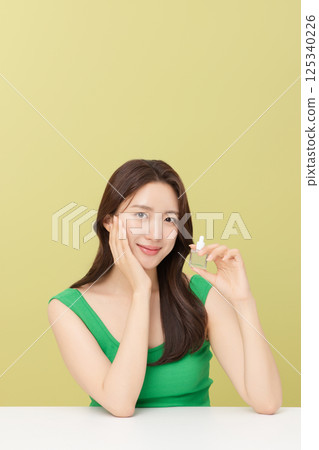 Portrait of young woman taking care of her nails 125340226